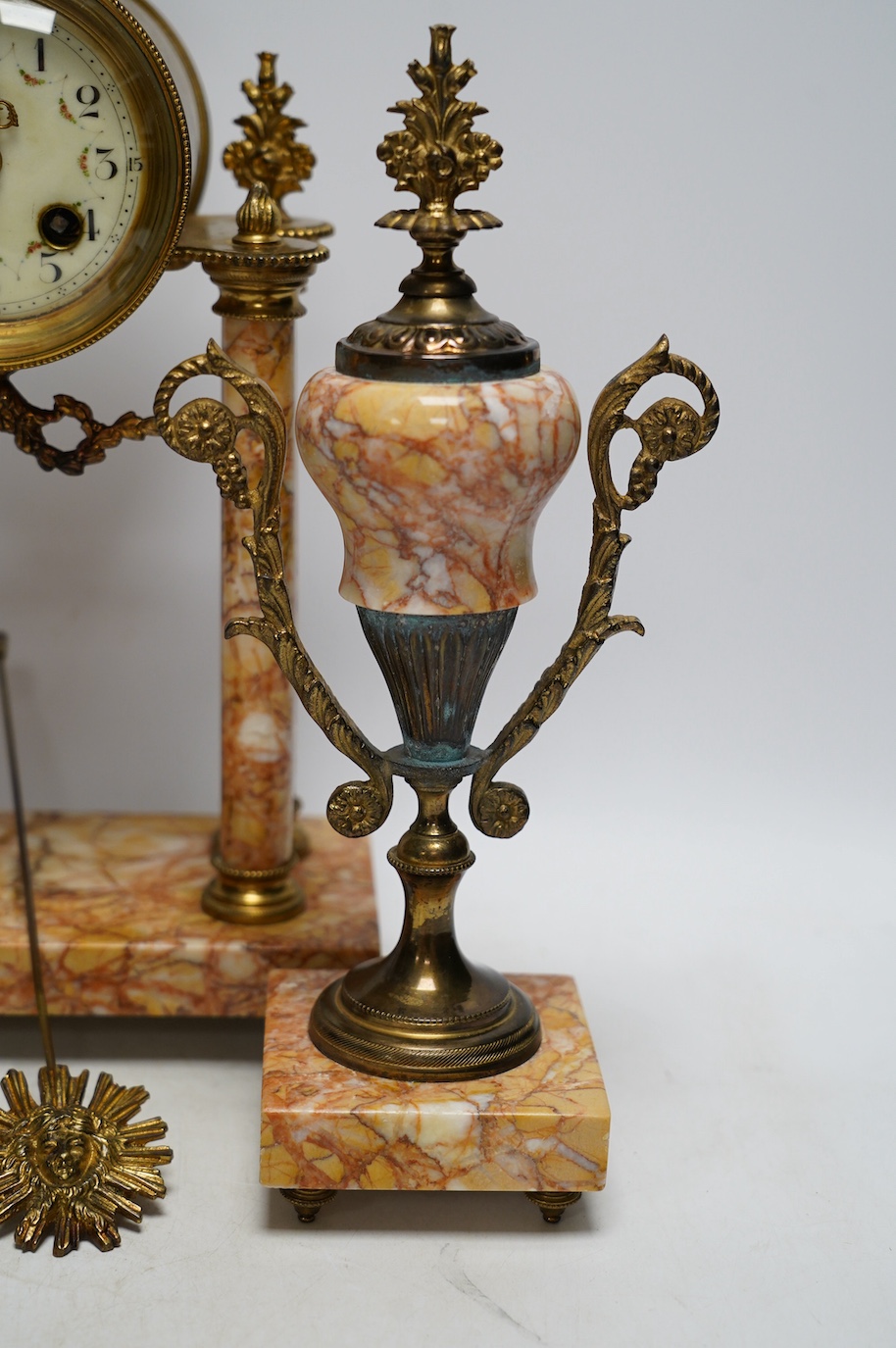 An early 20th century century French marble clock garniture, key and pendulum, 40cm. Condition - fair to good